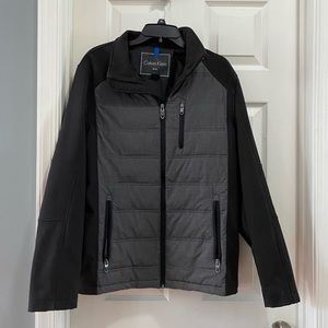 Calvin Klein soft-shell with zipper pockets. Great condition. Black and Gray.